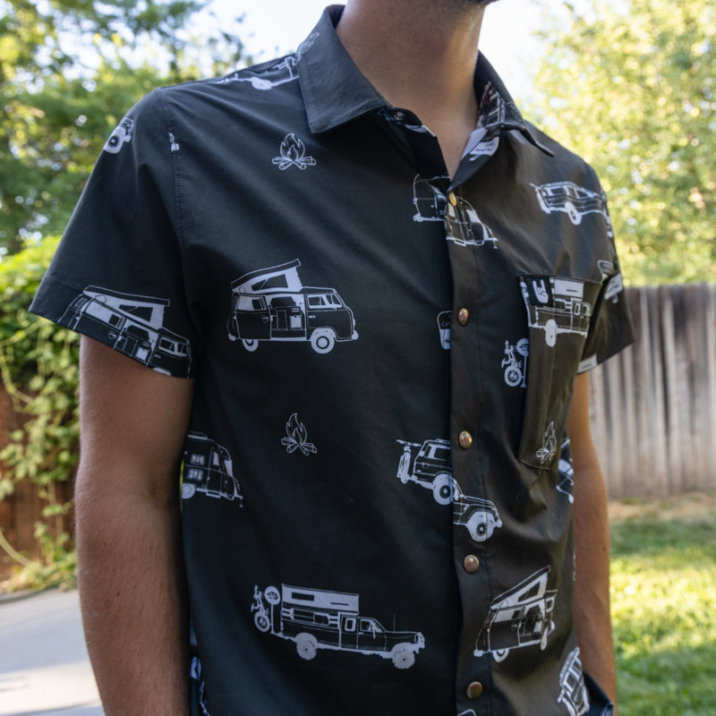 torso of a man wearing black rowdee weekender snap button short sleeve shirt.