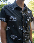 torso of a man wearing black rowdee weekender snap button short sleeve shirt.